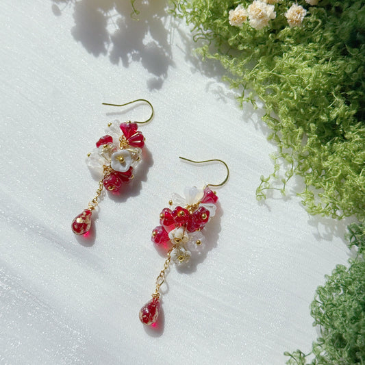 Handmade Czech glass flower cluster earrings in red and white tones, featuring small floral bead clusters and a dangling red teardrop detail, vibrant yet delicate design.
