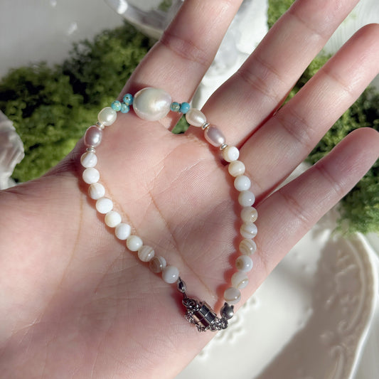 freshwater pearl bracelet with large iridescent focal pearl high luster pearls and shell beads handmade elegant jewelry