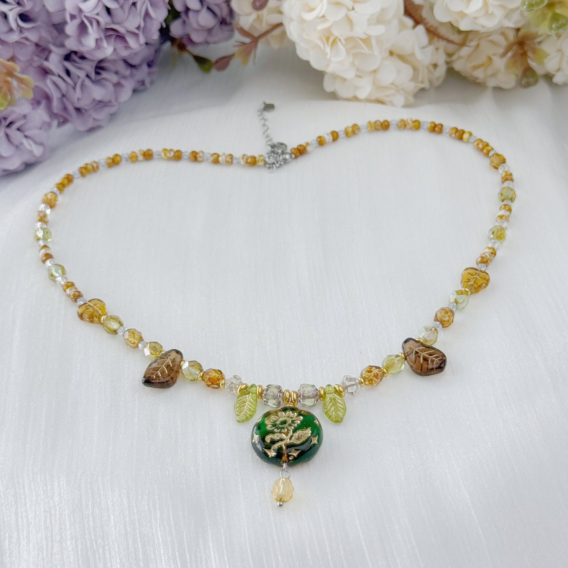 Czech glass botanical necklace with green floral pendant and leaf beads
