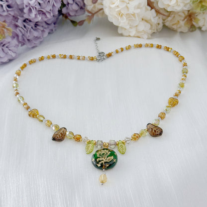 Czech glass botanical necklace with green floral pendant and leaf beads