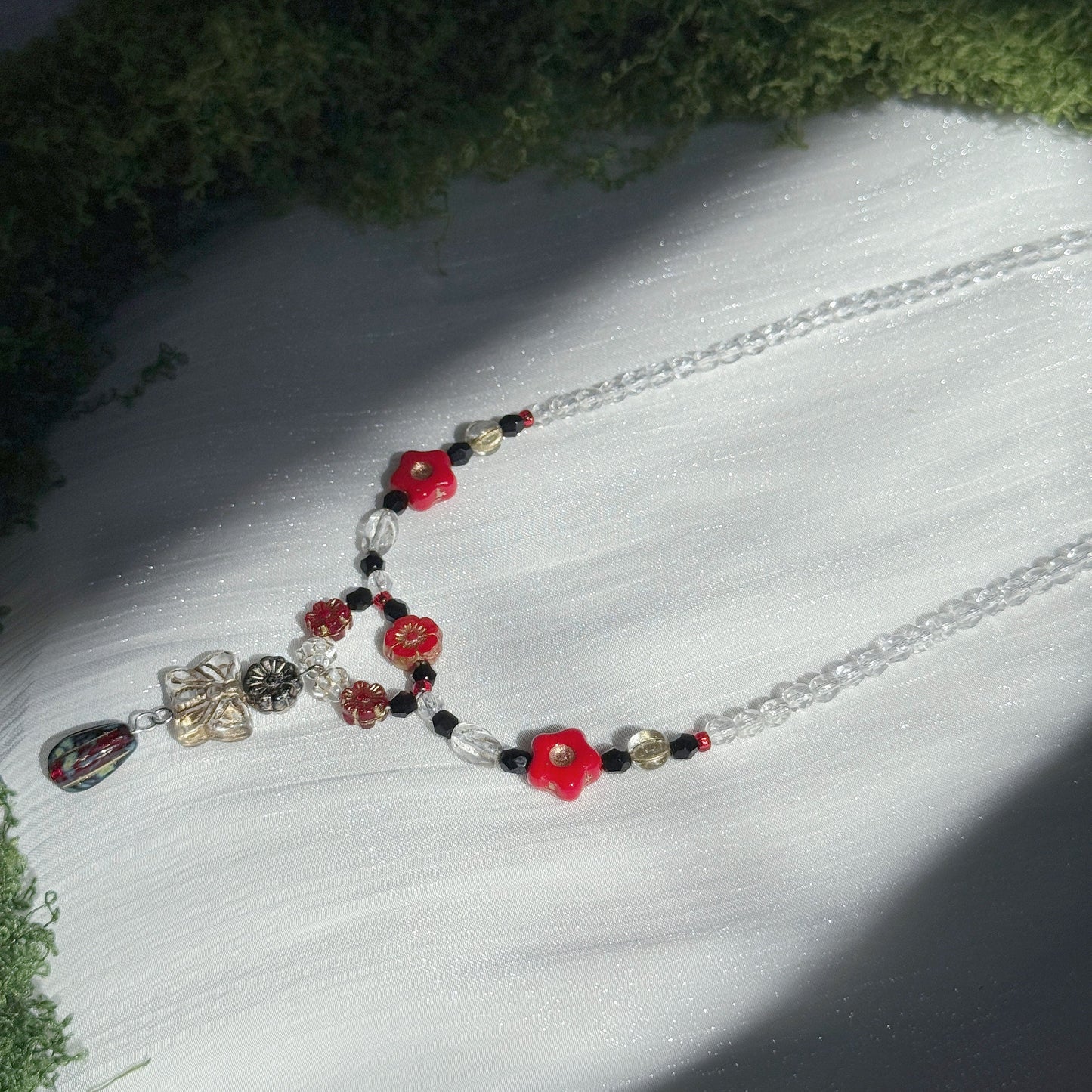 red and black handmade czech glass necklace with bright red flower beads butterfly pendant and beaded chain botanical jewelry