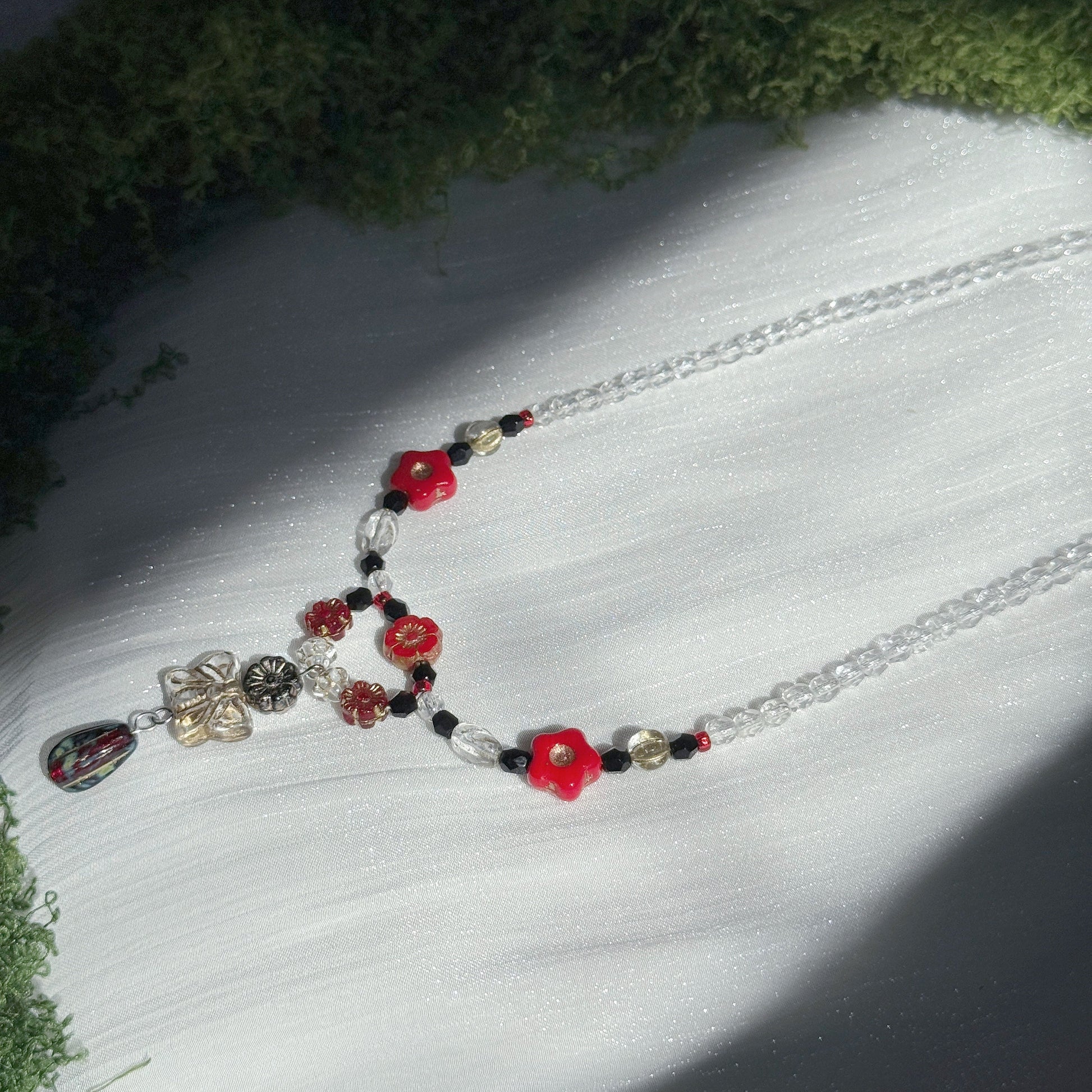 red and black handmade czech glass necklace with bright red flower beads butterfly pendant and beaded chain botanical jewelry