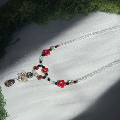 red and black handmade czech glass necklace with bright red flower beads butterfly pendant and beaded chain botanical jewelry