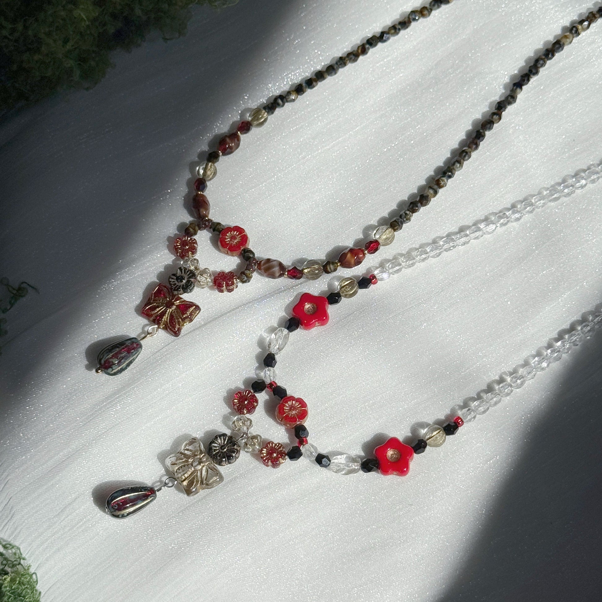 red and black handmade czech glass floral pendant necklaces with red flower beads and beaded chains botanical jewelry