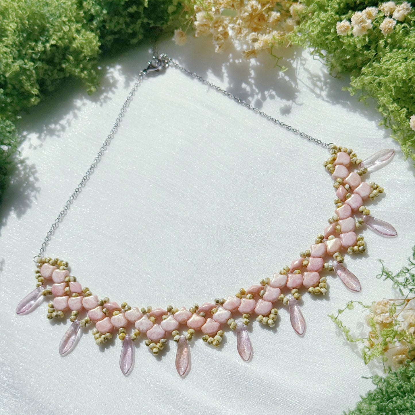 Pink beaded statement necklace with floral petal design and dangling glass accents, handmade jewelry with soft romantic style