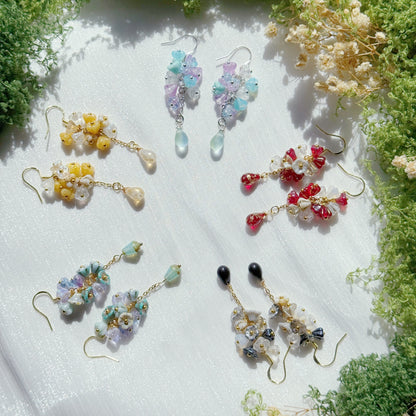 Handmade Czech glass flower cluster earrings in soft multicolor tones, featuring small floral bead clusters and a dangling teardrop detail, lightweight and nature-inspired design.