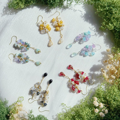 Handmade Czech glass flower cluster earrings in soft multicolor tones, featuring small floral bead clusters and a dangling teardrop detail, lightweight and nature-inspired design.