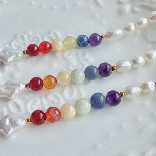 Bracelet with multicolored natural stone beads on a textured white surface