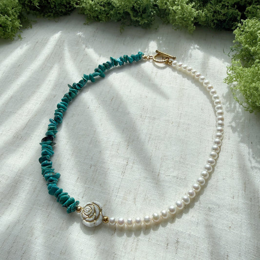 Handmade necklace featuring natural turquoise, freshwater pearls, and Czech glass rose beads on a soft linen background.