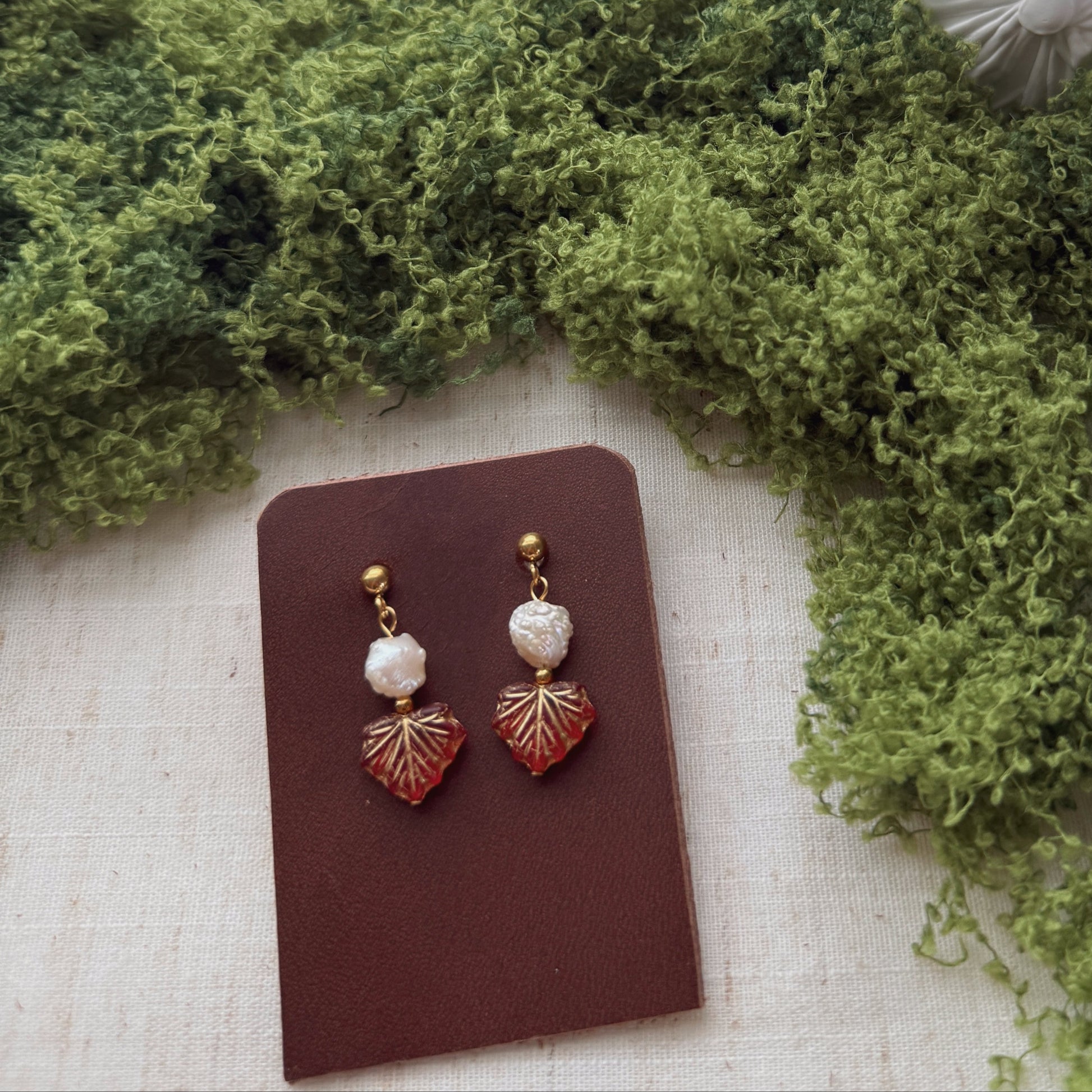 handmade earrings featuring red maple leaf beads and freshwaterpearls