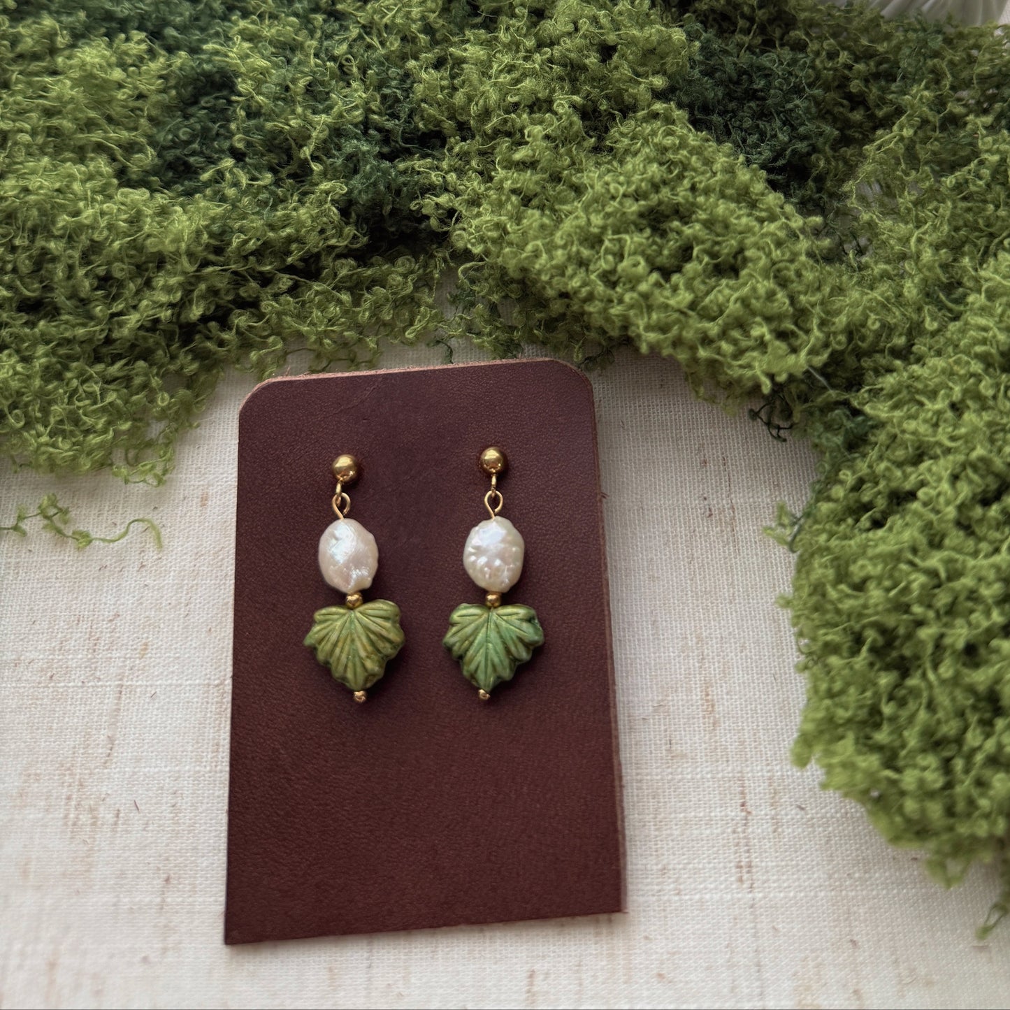 handmade earrings featuring green maple leaf beads and freshwaterpearls