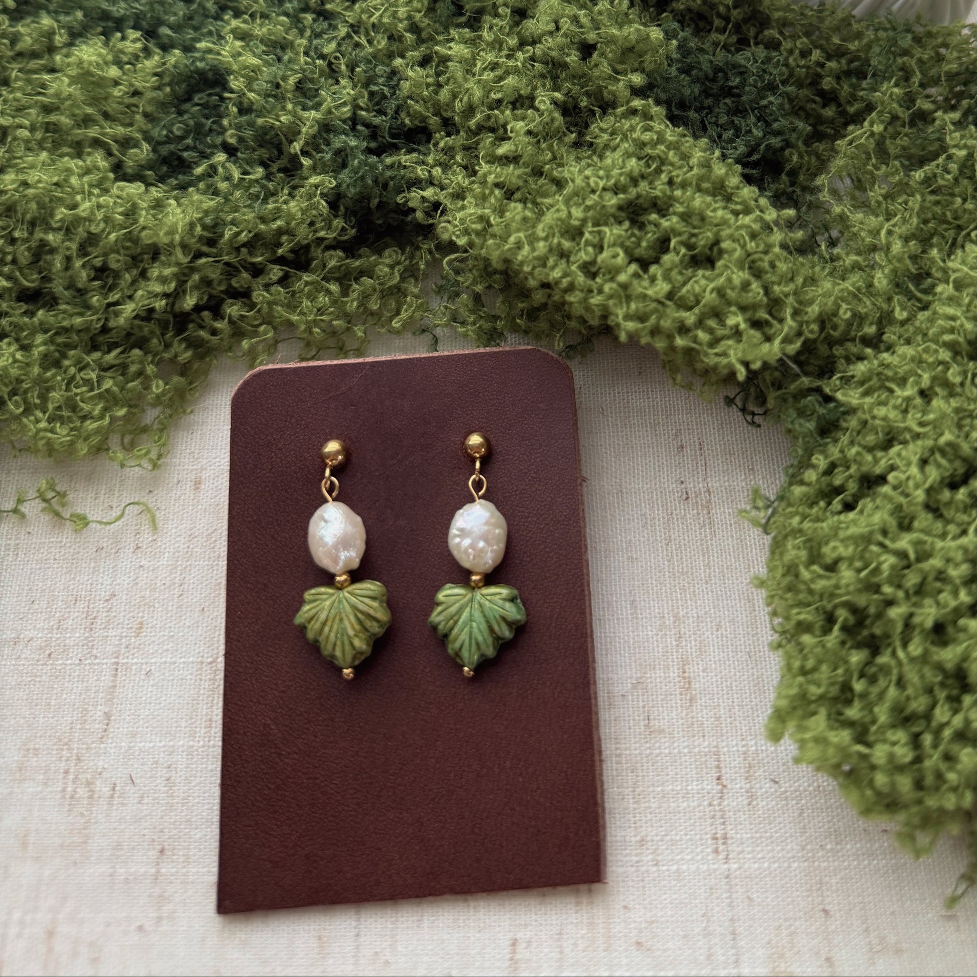 handmade earrings featuring green maple leaf beads and freshwaterpearls