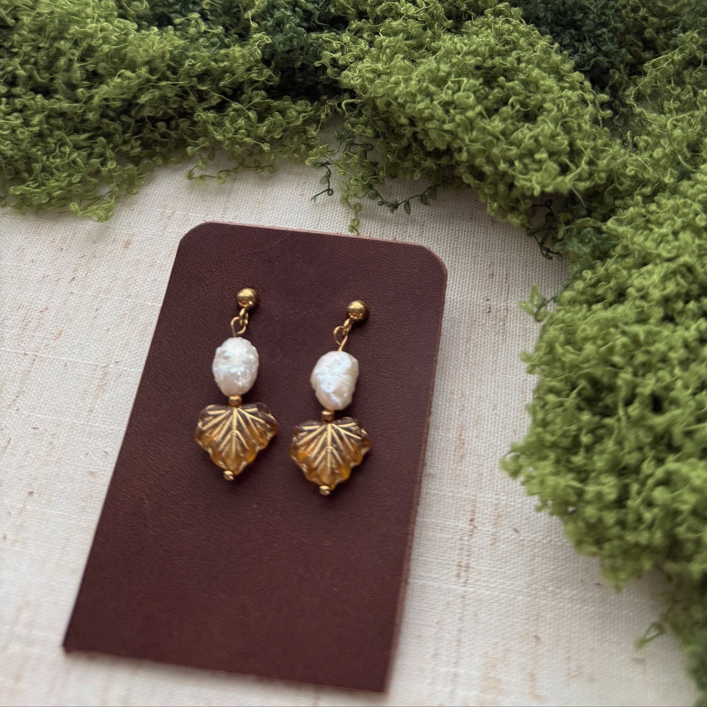 handmade earrings featuring amber color maple leaf beads and freshwater pearls