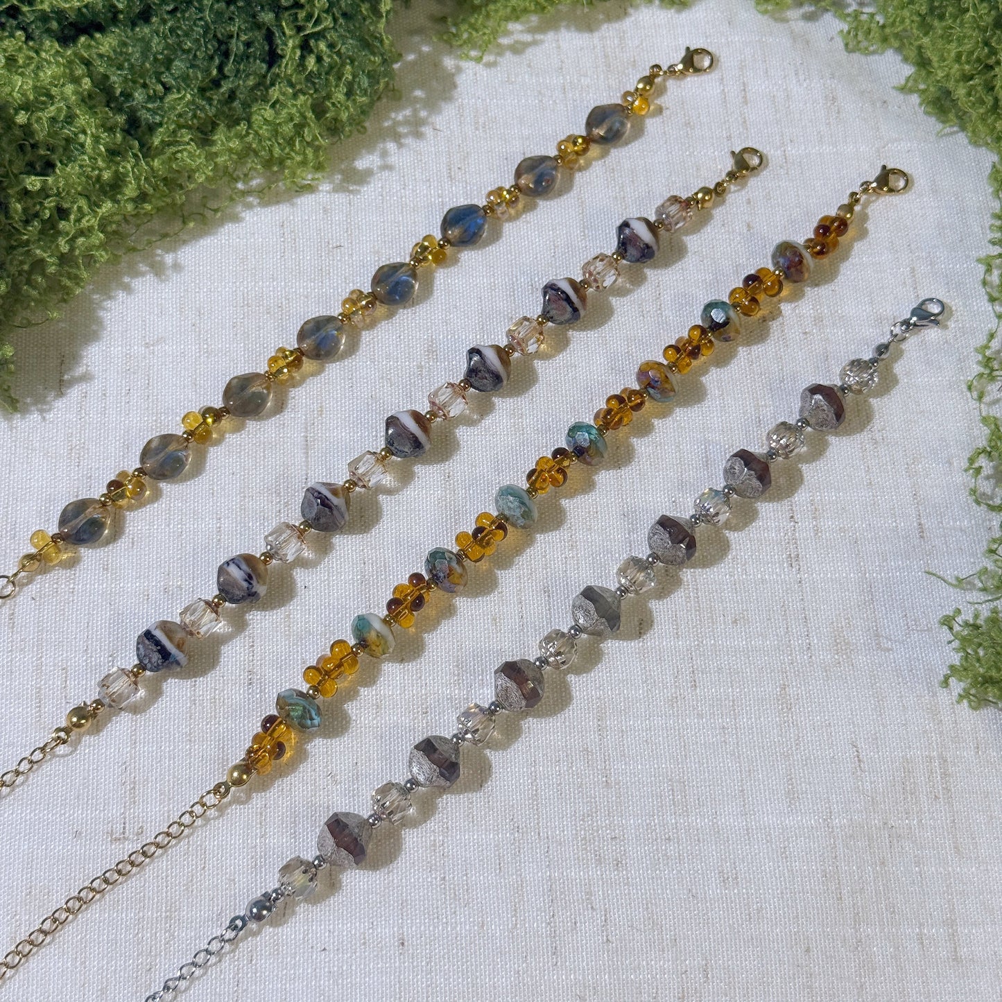 Four vintage-style bracelets with gold and silver tone.