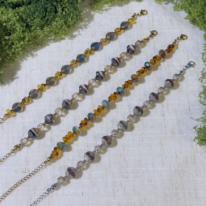 Four vintage-style bracelets with gold and silver tone.