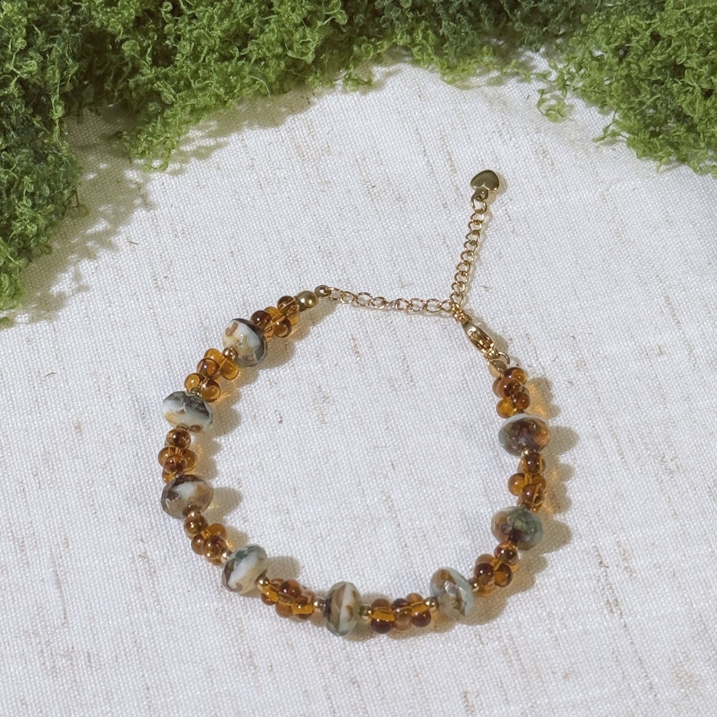 Vintage-style bracelet with gold tone and amber color  beads.