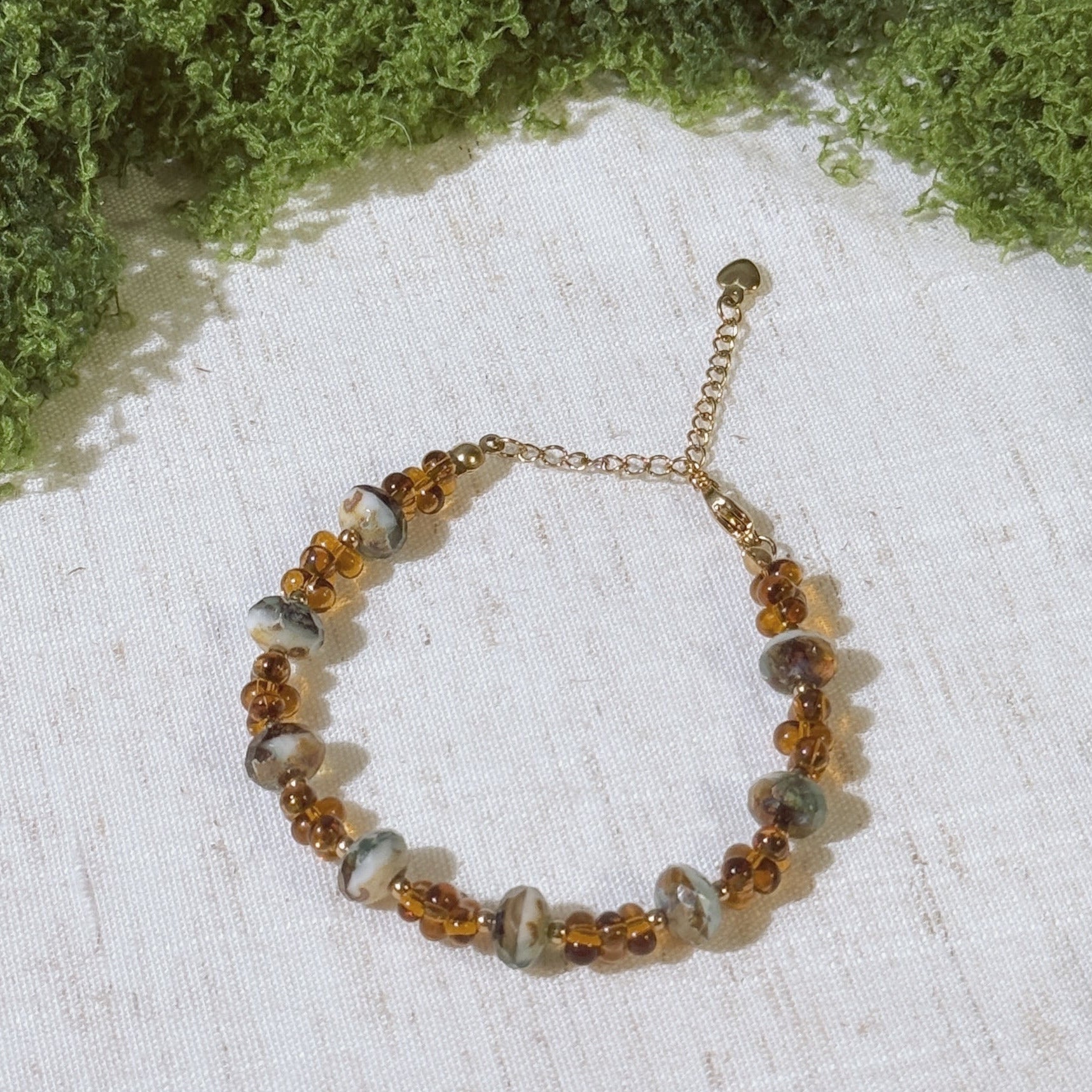 Vintage-style bracelet with gold tone and amber color  beads.