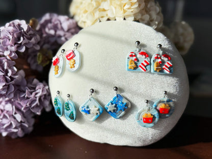 Colorful earrings displayed on a white stone with flowers in the background