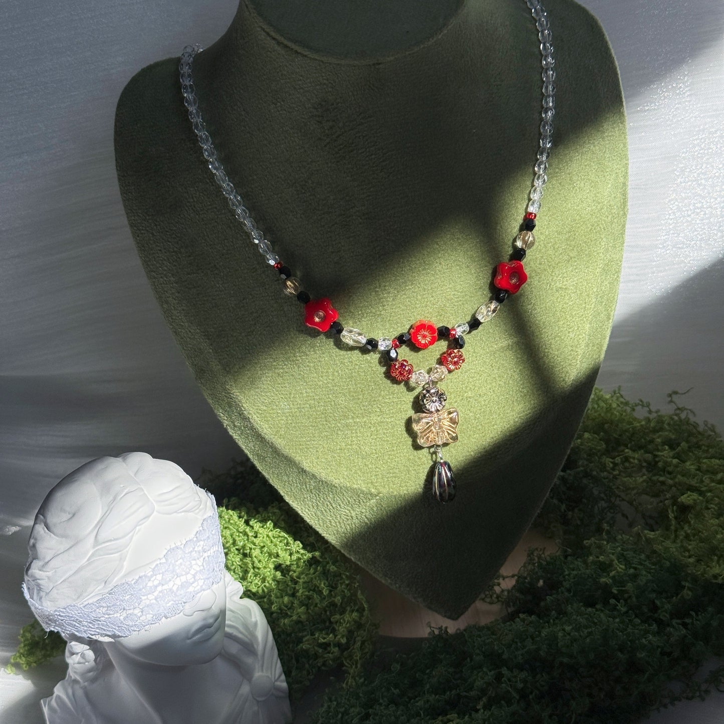 red and black handmade czech glass necklace with bright red flower beads butterfly pendant and beaded chain botanical jewelry